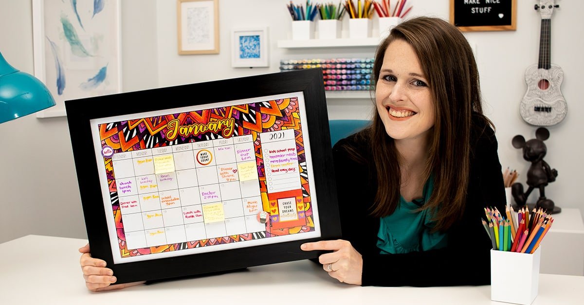 Sarah Renae Clark holding DIY whiteboard calendar