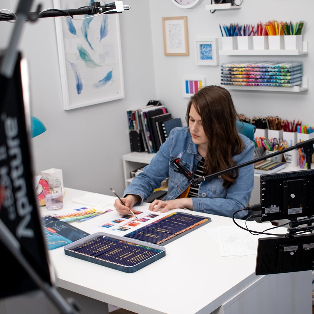 Sarah Renae Clark using Derwent Inktense colored pencils in art studio