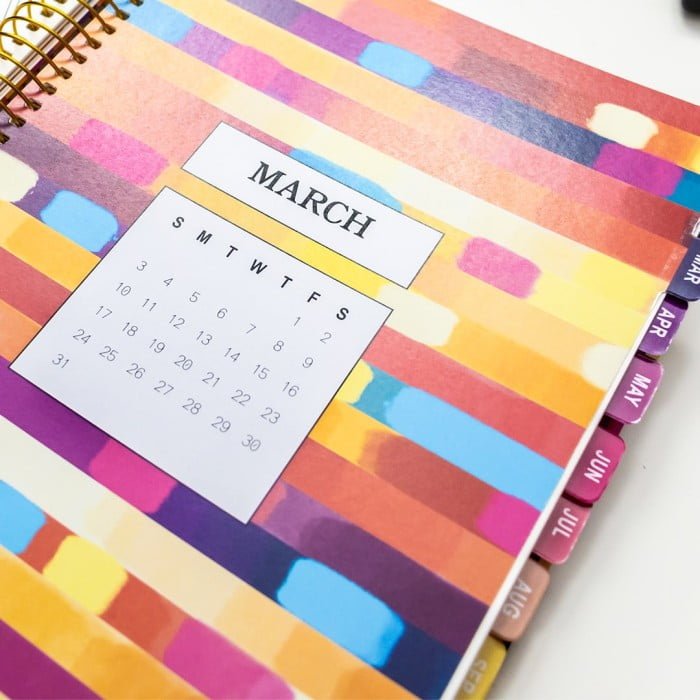 A4 2024 Coloring Planner opened on March colorful divider displaying month calendar and colorful tabs