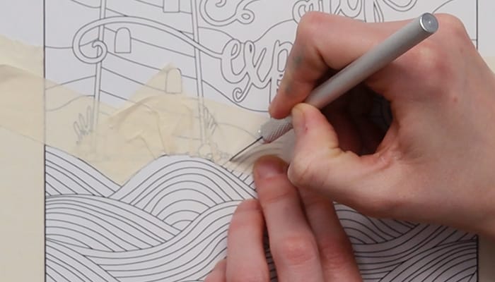 cutting away excess masking tape from a coloring page
