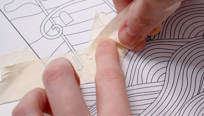 Applying masking tape to a coloring page