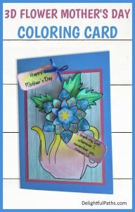 3D unique Mother's Day Coloring Card with a flower and watering can, colored in blues and pinks.